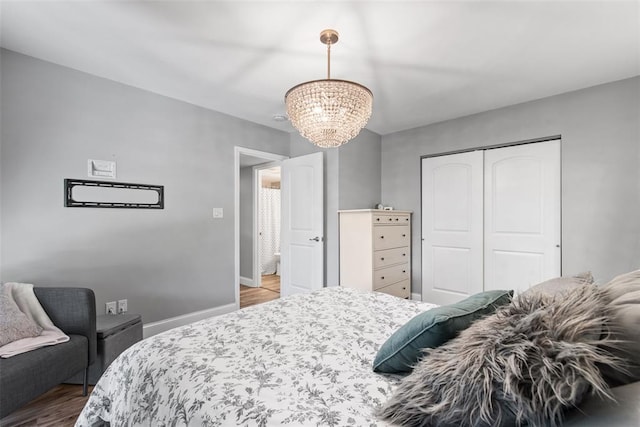 1491 Bobolink Pl, Brentwood, MO 63144 - bedroom featuring a chandelier, wood finished floors, a closet, and baseboards