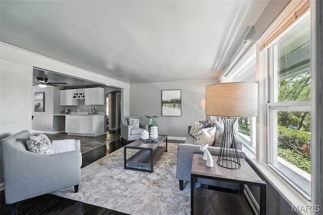 41 S Dellwood Ave, Saint Louis, MO 63135 - living room with dark wood-type flooring, baseboards, and a ceiling fan