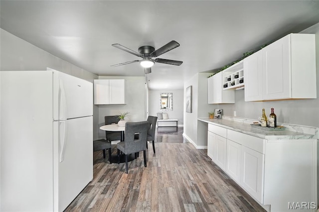 41 S Dellwood Ave, Saint Louis, MO 63135 - kitchen featuring freestanding refrigerator, wood finished floors, white cabinets, and a ceiling fan