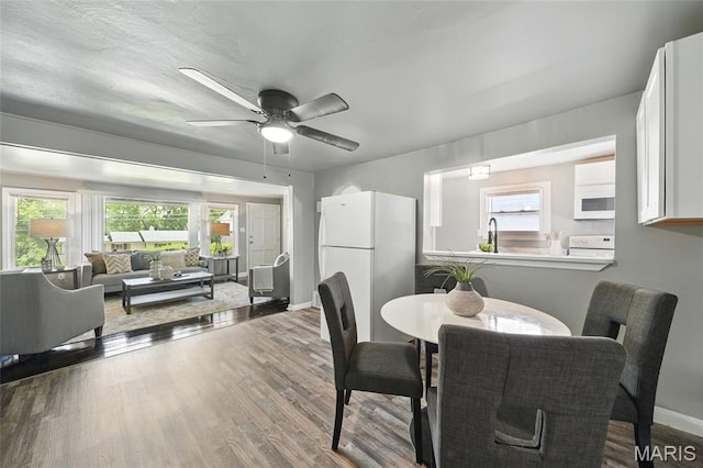 41 S Dellwood Ave, Saint Louis, MO 63135 - dining area featuring wood finished floors, a ceiling fan, and baseboards