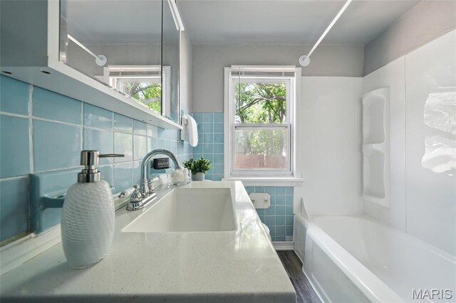 41 S Dellwood Ave, Saint Louis, MO 63135 - bathroom featuring tile walls,  shower combination, and vanity