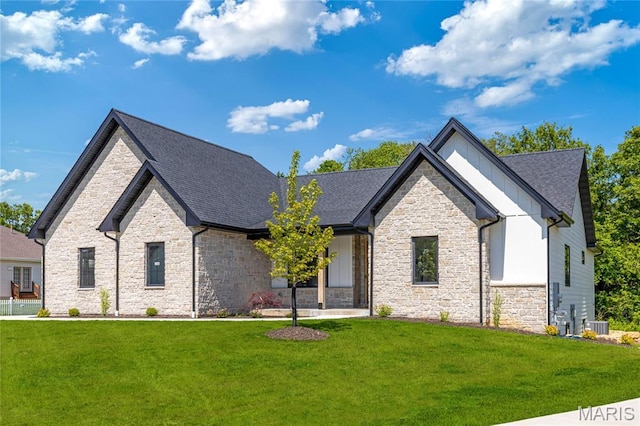 100 Enclave Terrace Ct, Weldon Spring, MO 63304 - view of front of home with stone siding, a front lawn, roof with shingles, cooling unit, and board and batten siding
