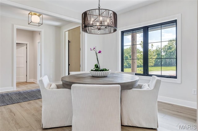 100 Enclave Terrace Ct, Weldon Spring, MO 63304 - dining space with light wood-style flooring, baseboards, and a chandelier