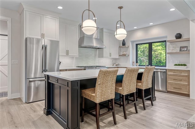 100 Enclave Terrace Ct, Weldon Spring, MO 63304 - kitchen featuring open shelves, stainless steel appliances, a kitchen island, light countertops, and light wood-type flooring