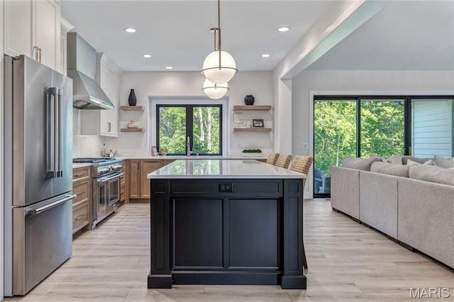 100 Enclave Terrace Ct, Weldon Spring, MO 63304 - kitchen with high end appliances, open shelves, wall chimney range hood, light countertops, and open floor plan