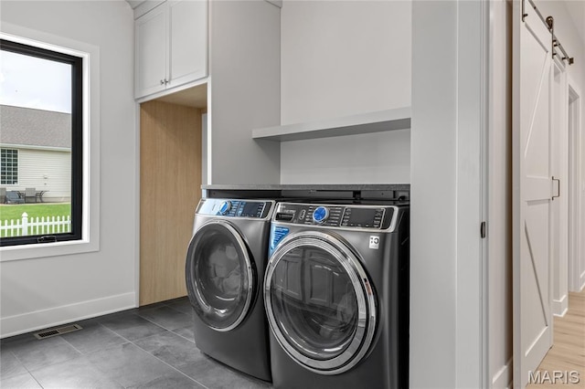 100 Enclave Terrace Ct, Weldon Spring, MO 63304 - laundry room with independent washer and dryer, baseboards, cabinet space, and dark tile patterned flooring