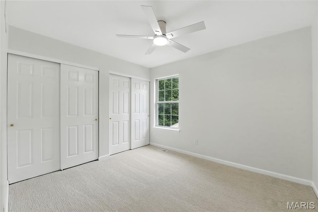 973 Kylemore Dr, Ballwin, MO 63021 - unfurnished bedroom with two closets, carpet flooring, baseboards, and ceiling fan