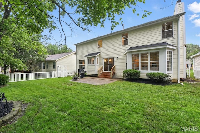 973 Kylemore Dr, Ballwin, MO 63021 - back of house featuring entry steps, a patio area, and a chimney
