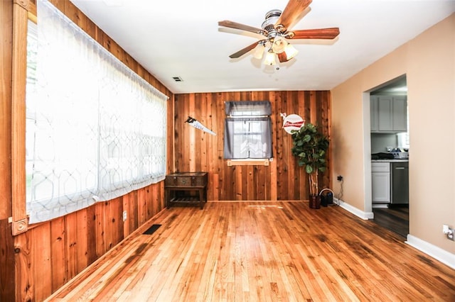 6195 Cedar Springs Rd, Cedar Hill, MO 63016 - unfurnished room featuring hardwood / wood-style floors, wood walls, ceiling fan, and baseboards
