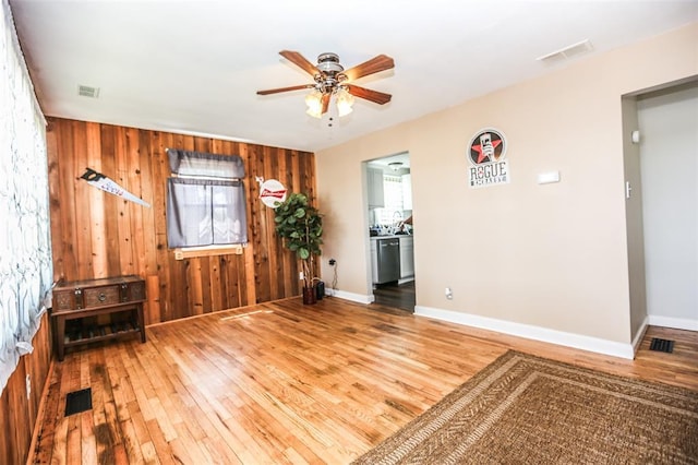 6195 Cedar Springs Rd, Cedar Hill, MO 63016 - unfurnished room featuring a ceiling fan, hardwood / wood-style floors, wooden walls, and baseboards