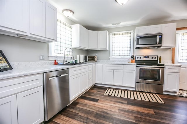 6195 Cedar Springs Rd, Cedar Hill, MO 63016 - kitchen featuring appliances with stainless steel finishes, a sink, light countertops, white cabinetry, and dark wood-style flooring