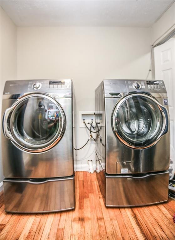 6195 Cedar Springs Rd, Cedar Hill, MO 63016 - laundry room with separate washer and dryer, wood finished floors, and baseboards