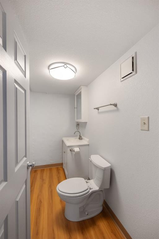 2831 Dunkirk Dr, Saint Louis, MO 63119 - bathroom featuring wood finished floors, toilet, baseboards, and vanity
