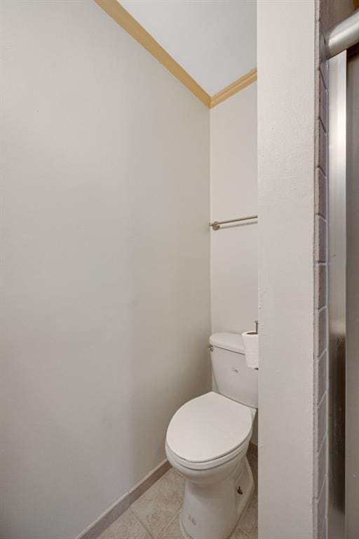 2831 Dunkirk Dr, Saint Louis, MO 63119 - bathroom with crown molding, toilet, tile patterned floors, and baseboards