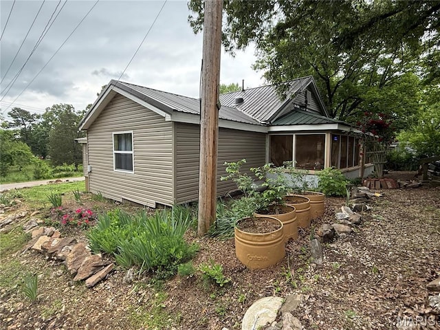 929 Race St, Thayer, MO 65791 - view of side of home with a sunroom and a metal roof