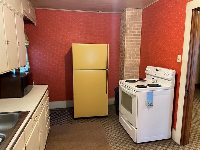 500 E 10th St, Salem, MO 65560 - kitchen with white appliances, wallpapered walls, light countertops, a sink, and white cabinets
