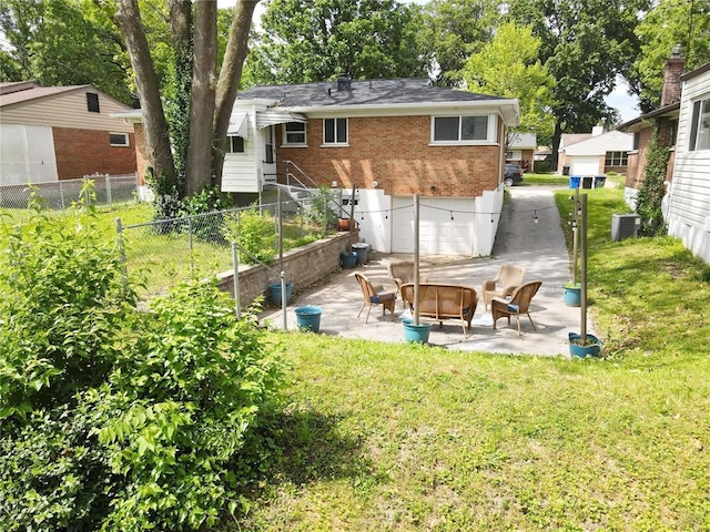 7448 Ahern Ave, Saint Louis, MO 63130 - back of house featuring an outdoor fire pit, brick siding, a patio area, and central AC unit