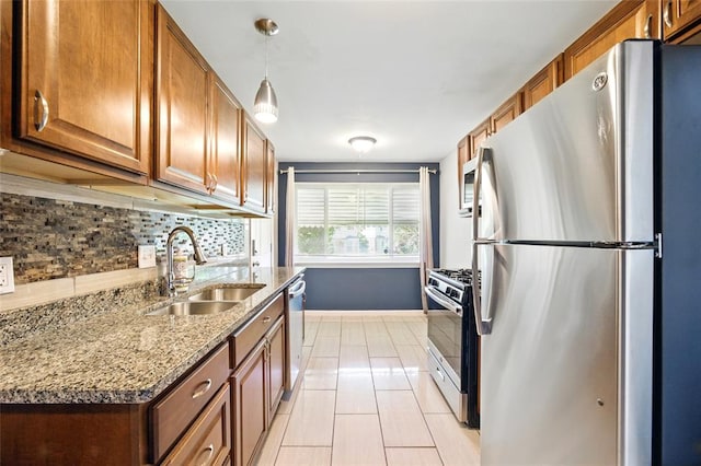 7448 Ahern Ave, Saint Louis, MO 63130 - kitchen featuring appliances with stainless steel finishes, a sink, decorative backsplash, and brown cabinets