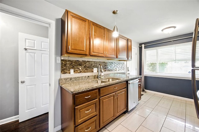 7448 Ahern Ave, Saint Louis, MO 63130 - kitchen with stainless steel dishwasher, a sink, decorative backsplash, light stone counters, and brown cabinetry