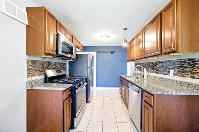 7448 Ahern Ave, Saint Louis, MO 63130 - kitchen featuring stainless steel appliances, a sink, tasteful backsplash, and brown cabinetry