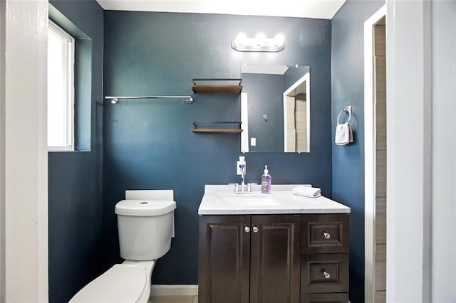 7448 Ahern Ave, Saint Louis, MO 63130 - bathroom featuring toilet, vanity, and baseboards