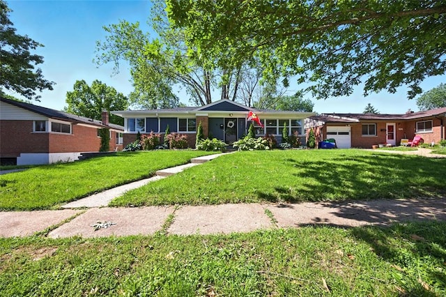 7448 Ahern Ave, Saint Louis, MO 63130 - ranch-style home featuring an attached garage, a front yard, and brick siding