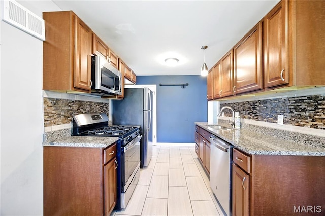 7448 Ahern Ave, Saint Louis, MO 63130 - kitchen featuring appliances with stainless steel finishes, backsplash, and brown cabinetry