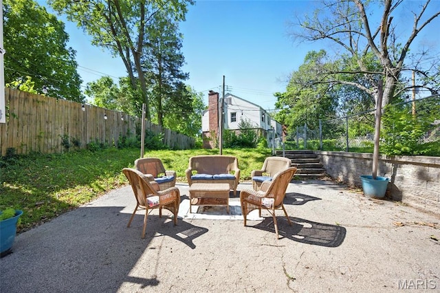 7448 Ahern Ave, Saint Louis, MO 63130 - fenced backyard featuring a patio area, an outdoor living space, and stairway