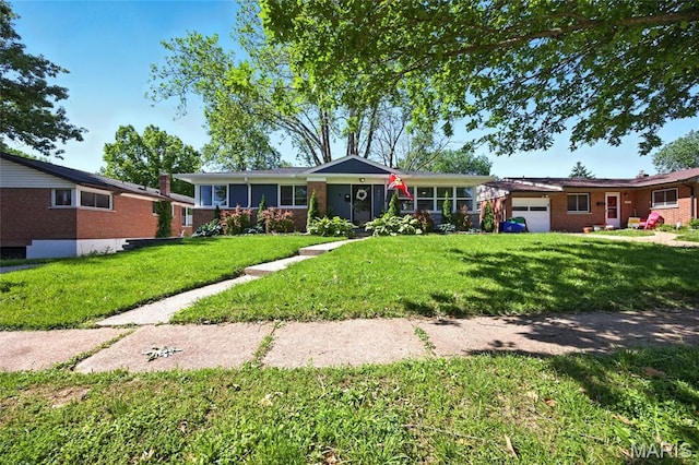 7448 Ahern Ave, Saint Louis, MO 63130 - ranch-style home with an attached garage, a front yard, and brick siding