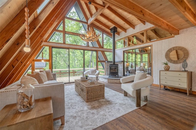 1129 Mitten Ridge Dr, Innsbrook, MO 63390 - living area with a wood stove, wood finished floors, a chandelier, high vaulted ceiling, and wooden ceiling with exposed beams