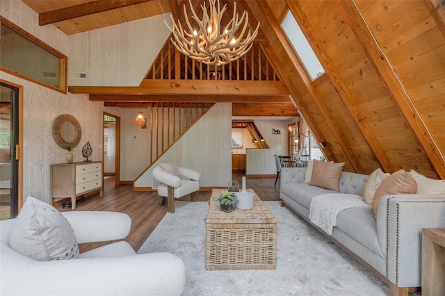 1129 Mitten Ridge Dr, Innsbrook, MO 63390 - living room featuring a chandelier, wood finished floors, stairs, high vaulted ceiling, and a skylight