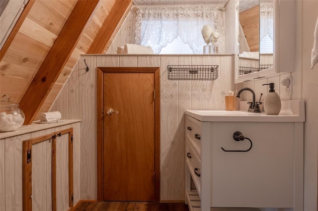 1129 Mitten Ridge Dr, Innsbrook, MO 63390 - bathroom with plenty of natural light, wooden ceiling, lofted ceiling, a sink, and wood walls