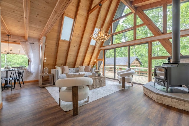 1129 Mitten Ridge Dr, Innsbrook, MO 63390 - living room featuring a chandelier, a wood stove, high vaulted ceiling, wood finished floors, and wood ceiling with exposed beams