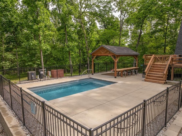 1129 Mitten Ridge Dr, Innsbrook, MO 63390 - view of swimming pool featuring a gazebo, a patio, view of scattered trees, a deck, and stairway