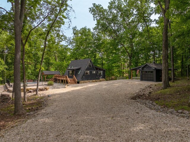1129 Mitten Ridge Dr, Innsbrook, MO 63390 - view of front facade with dirt driveway, an outbuilding, and a wooden deck