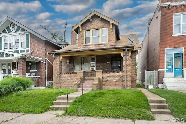 4545 Alice Ave, Saint Louis, MO 63115 - view of front of home with a porch, a front lawn, and brick siding