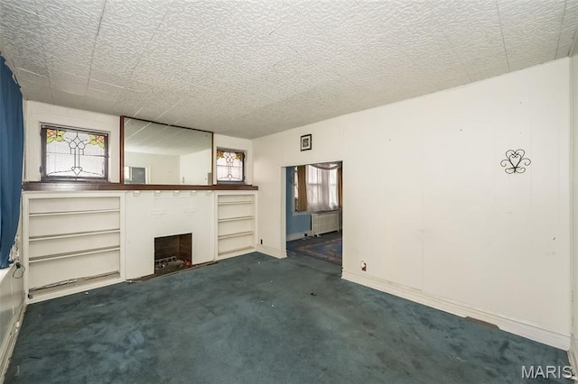 4545 Alice Ave, Saint Louis, MO 63115 - unfurnished living room with carpet, a fireplace, and radiator