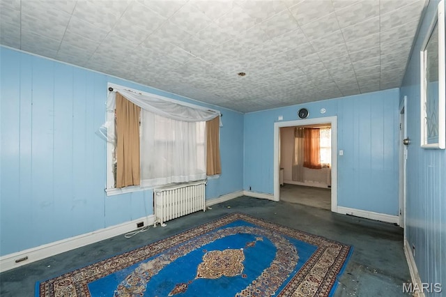 4545 Alice Ave, Saint Louis, MO 63115 - spare room featuring radiator and concrete flooring