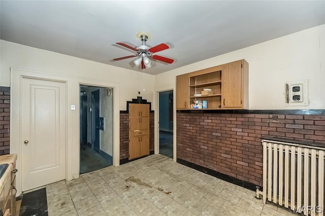 4545 Alice Ave, Saint Louis, MO 63115 - kitchen with radiator, a ceiling fan, open shelves, brown cabinets, and light floors