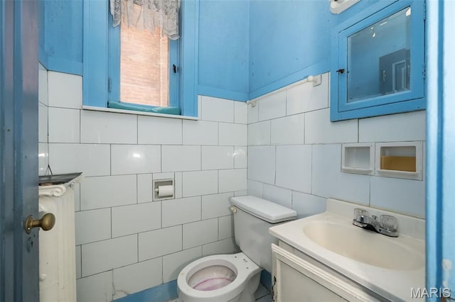 4545 Alice Ave, Saint Louis, MO 63115 - bathroom with tile walls, vanity, and backsplash