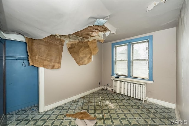 4545 Alice Ave, Saint Louis, MO 63115 - unfurnished bedroom featuring radiator heating unit and tile patterned floors