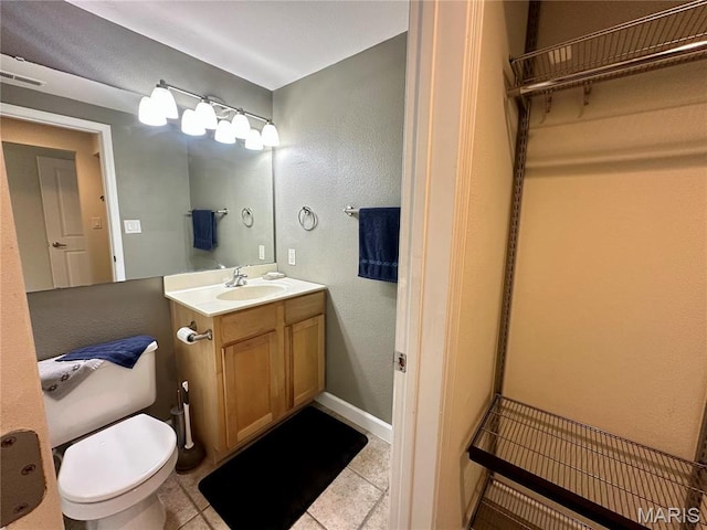 5330 Pershing Ave Unit 402, Saint Louis, MO 63112 - bathroom with vanity, toilet, tile patterned flooring, a textured wall, and baseboards