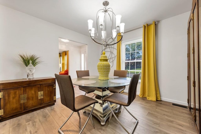 11943 Brookington Dr, Bridgeton, MO 63044 - dining area with a chandelier, light wood-type flooring, and baseboards
