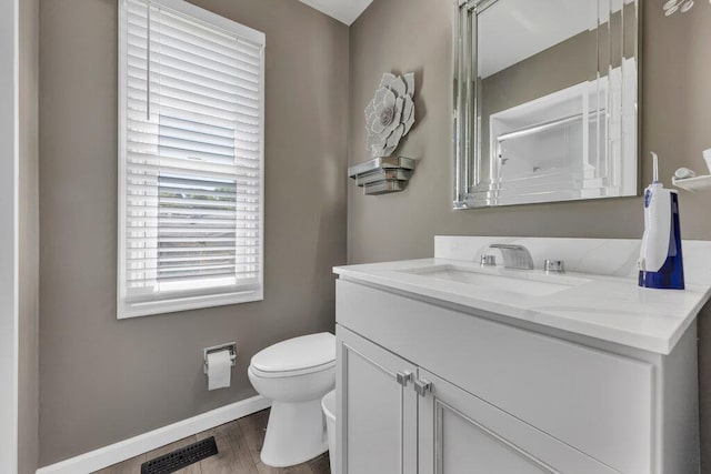 11943 Brookington Dr, Bridgeton, MO 63044 - bathroom featuring toilet, vanity, a shower, wood finished floors, and baseboards