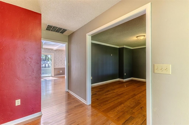 21509 Rockwell Dr, Lebanon, MO 65536 - hall featuring a textured ceiling, wood finished floors, baseboards, and a textured wall