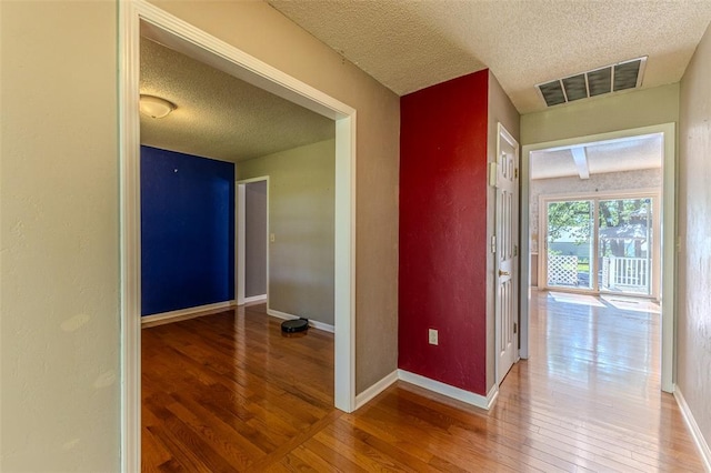 21509 Rockwell Dr, Lebanon, MO 65536 - corridor with a textured ceiling, hardwood / wood-style floors, and baseboards