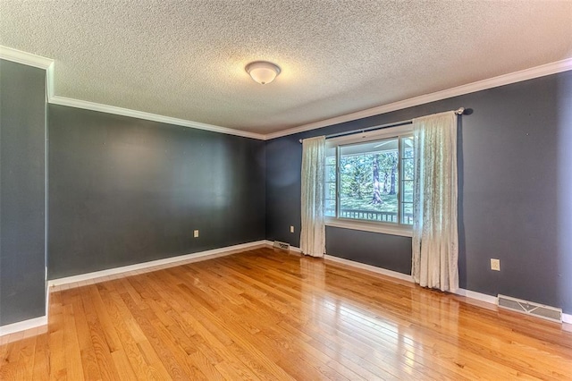 21509 Rockwell Dr, Lebanon, MO 65536 - empty room with wood finished floors, ornamental molding, baseboards, and a textured ceiling