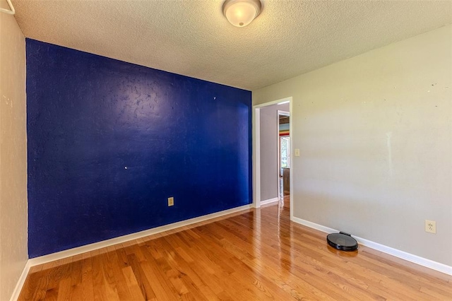 21509 Rockwell Dr, Lebanon, MO 65536 - unfurnished room featuring wood finished floors, a textured ceiling, and baseboards