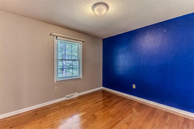 21509 Rockwell Dr, Lebanon, MO 65536 - unfurnished room with wood finished floors, a textured ceiling, and baseboards