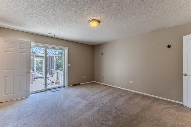 21509 Rockwell Dr, Lebanon, MO 65536 - spare room featuring carpet flooring, baseboards, and a textured ceiling